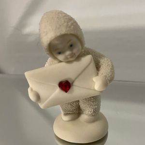 Snow Baby “Special Delivery.” with a garnet stone.